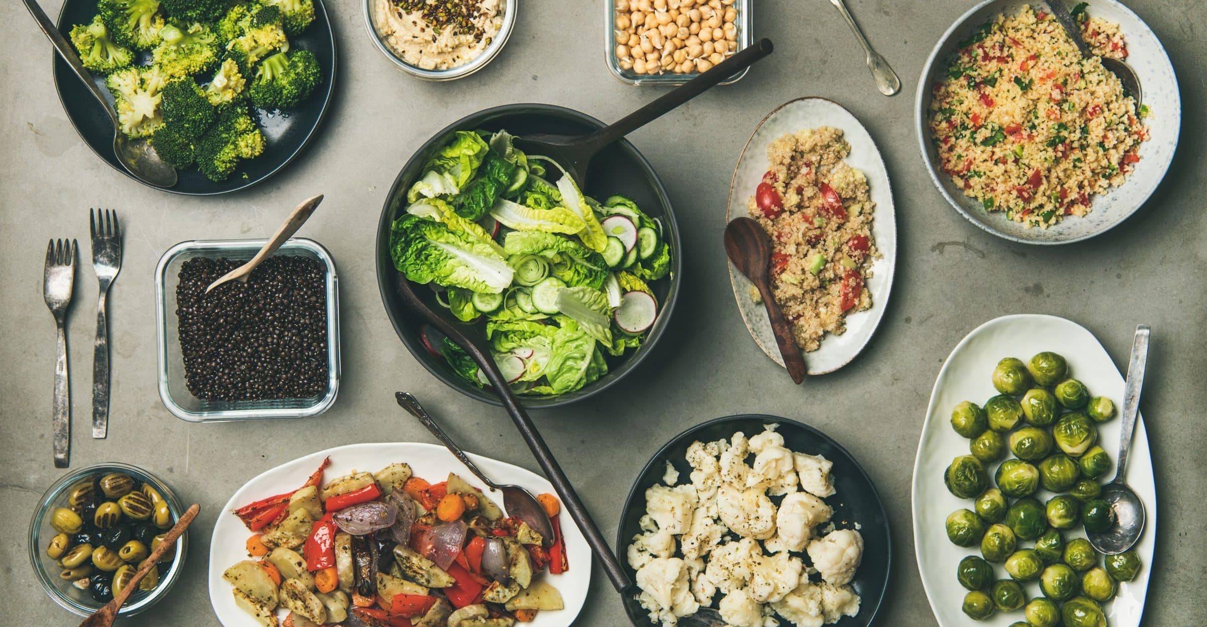 Table of bowls with grains, legumes and vegetables