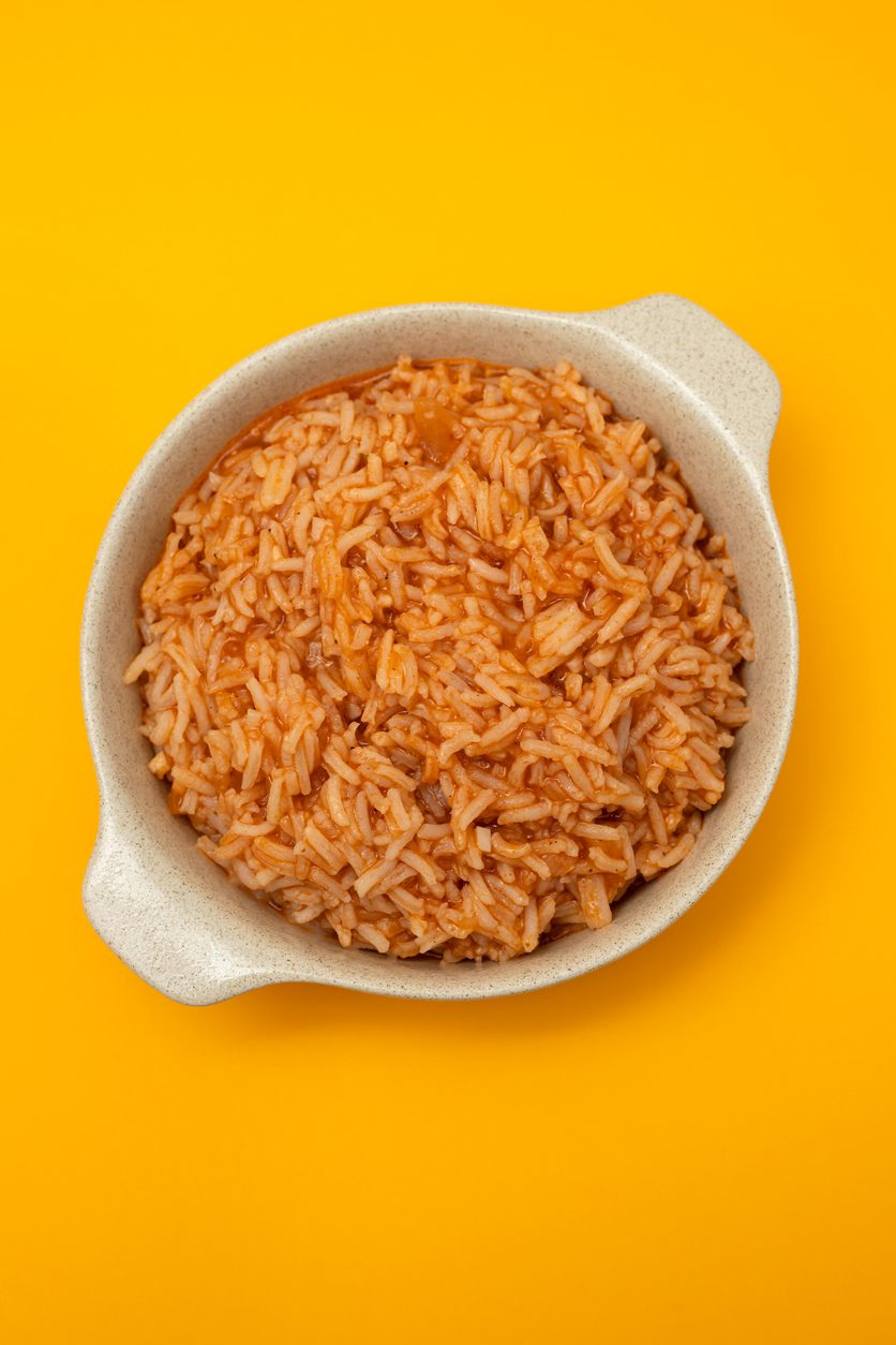 tomato rice on the dish on yellow background